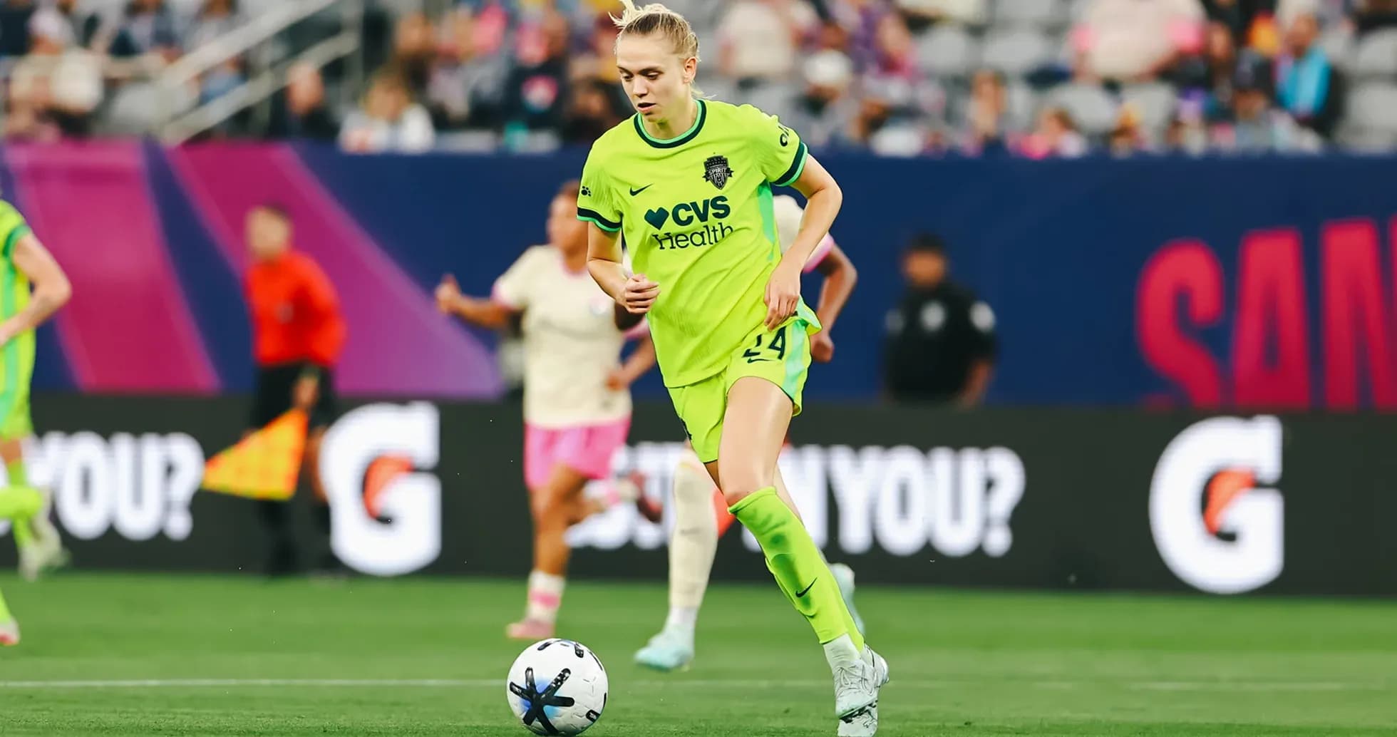 Player in green kit dribbling the ball Player in green kit dribbling the ball