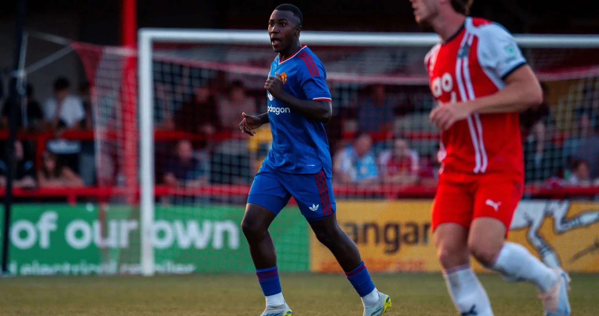 Player in blue kit running during a match Player in blue kit running during a match