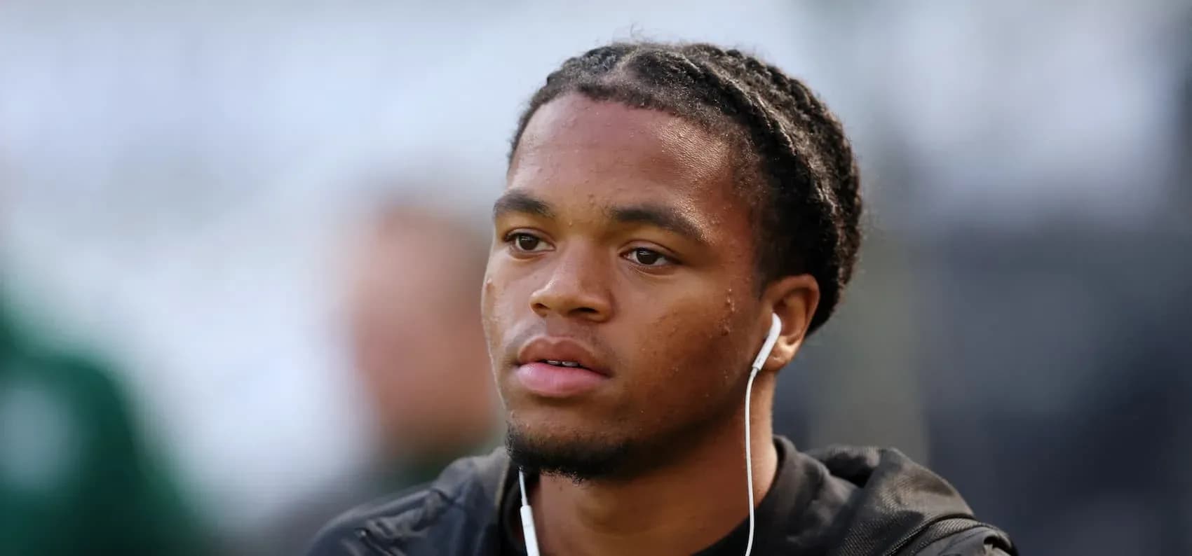 Player with headphones during warm-up session Player with headphones during warm-up session