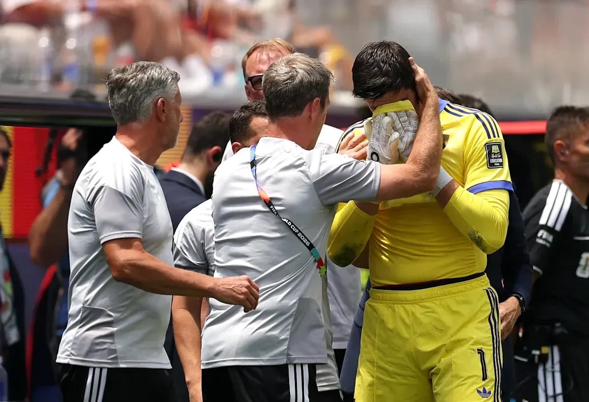 Goalkeeper receiving support from coaching staff during match Goalkeeper receiving support from coaching staff during match