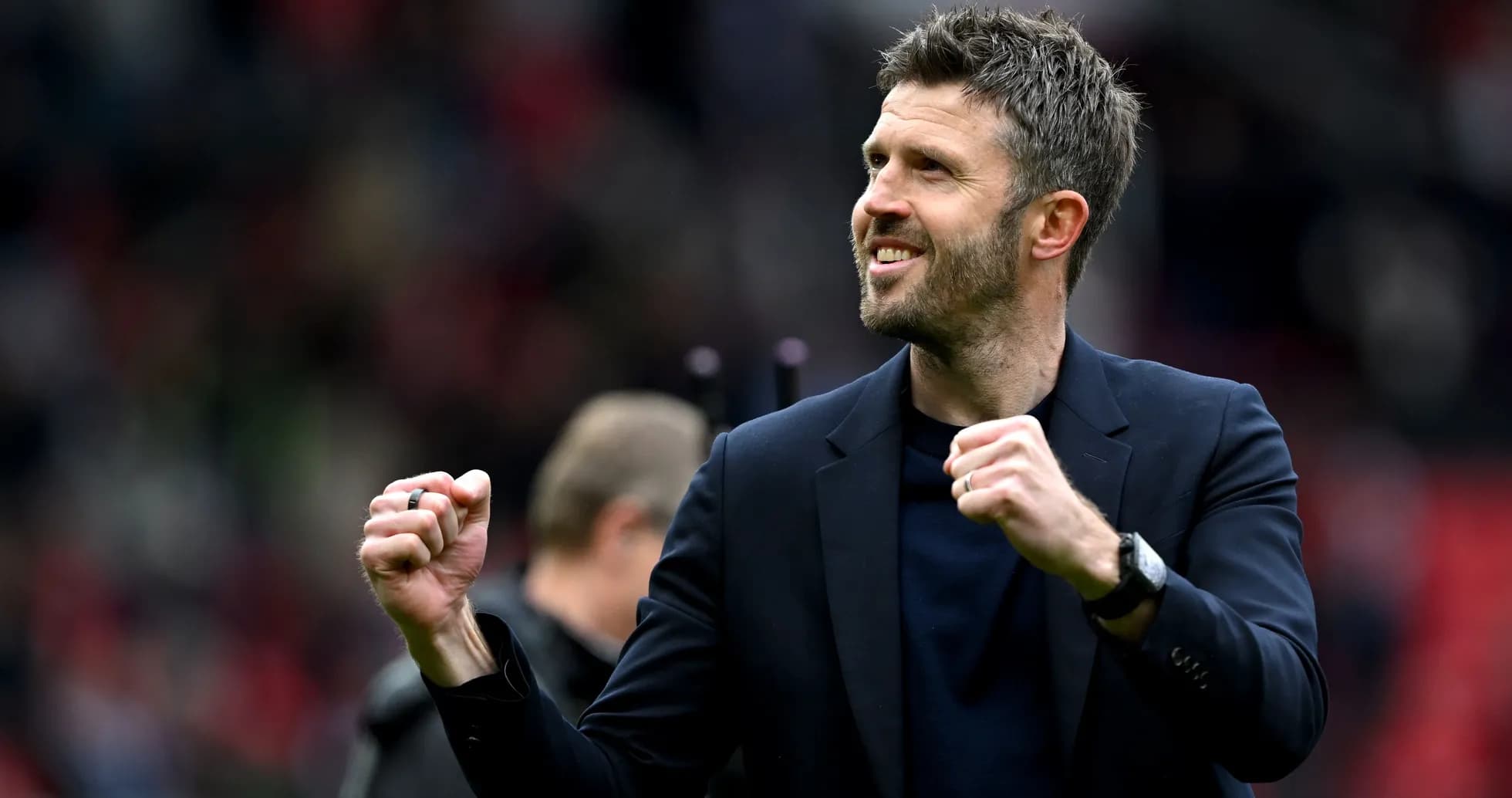 Manager celebrating with clenched fists on pitch Manager celebrating with clenched fists on pitch