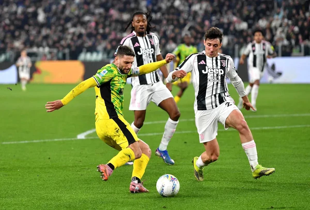 Player tackling opponent during Juventus match Player tackling opponent during Juventus match