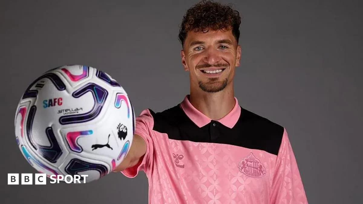 Player posing with a soccer ball in studio Player posing with a soccer ball in studio