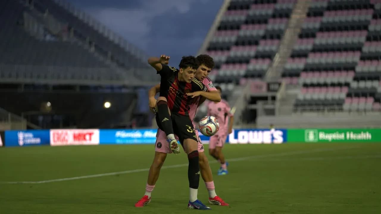 Atlanta United II player challenging Inter Miami II opponent Atlanta United II player challenging Inter Miami II opponent