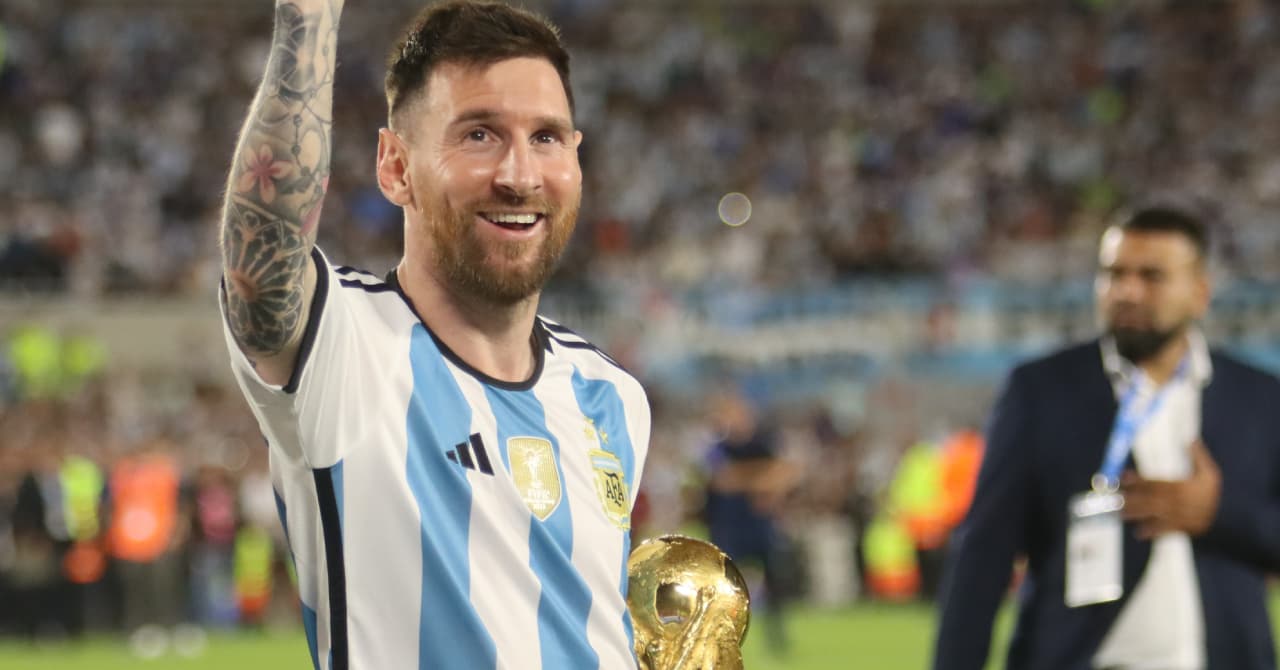 Player celebrating with World Cup trophy in stadium Player celebrating with World Cup trophy in stadium