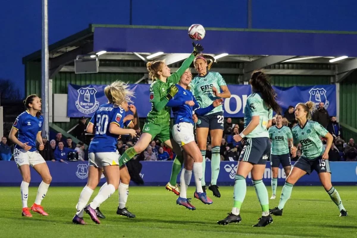 Goalkeeper attempting to catch the ball during match Goalkeeper attempting to catch the ball during match