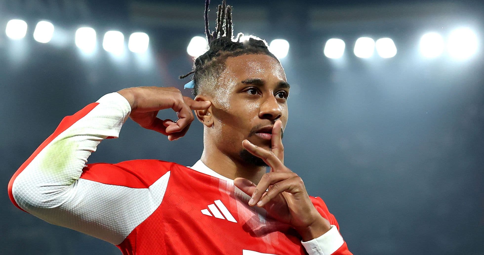 Player celebrating a goal with finger to lips Player celebrating a goal with finger to lips