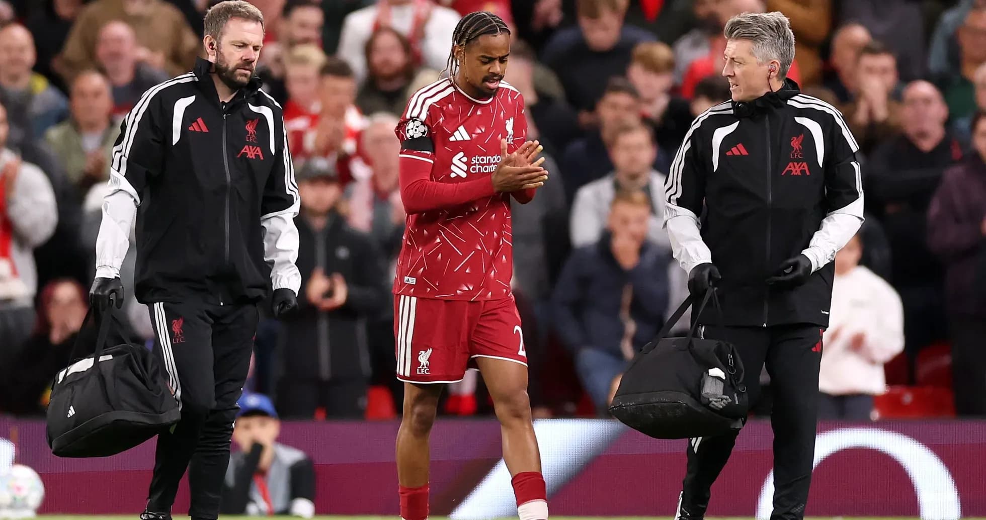 Liverpool player being assisted off the field by staff Liverpool player being assisted off the field by staff
