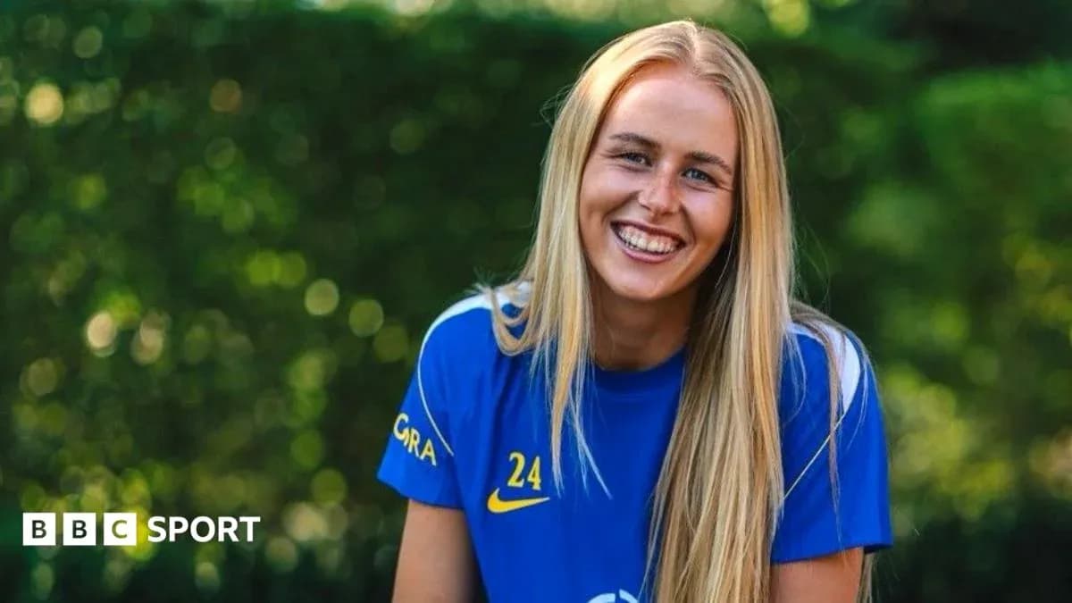 Female athlete smiling in blue sports jersey Female athlete smiling in blue sports jersey