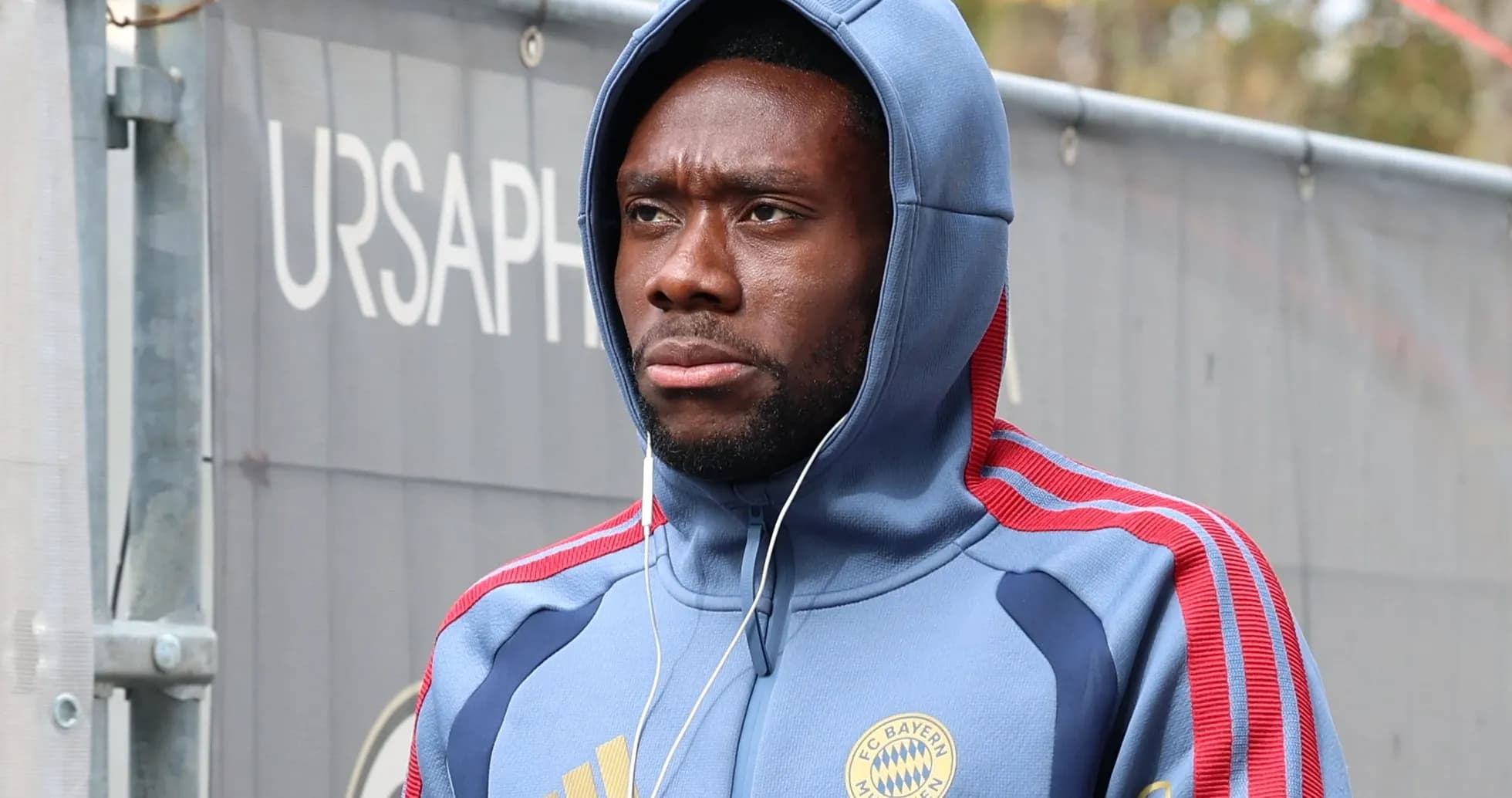 Player wearing Bayern Munich hoodie walking outdoors Player wearing Bayern Munich hoodie walking outdoors