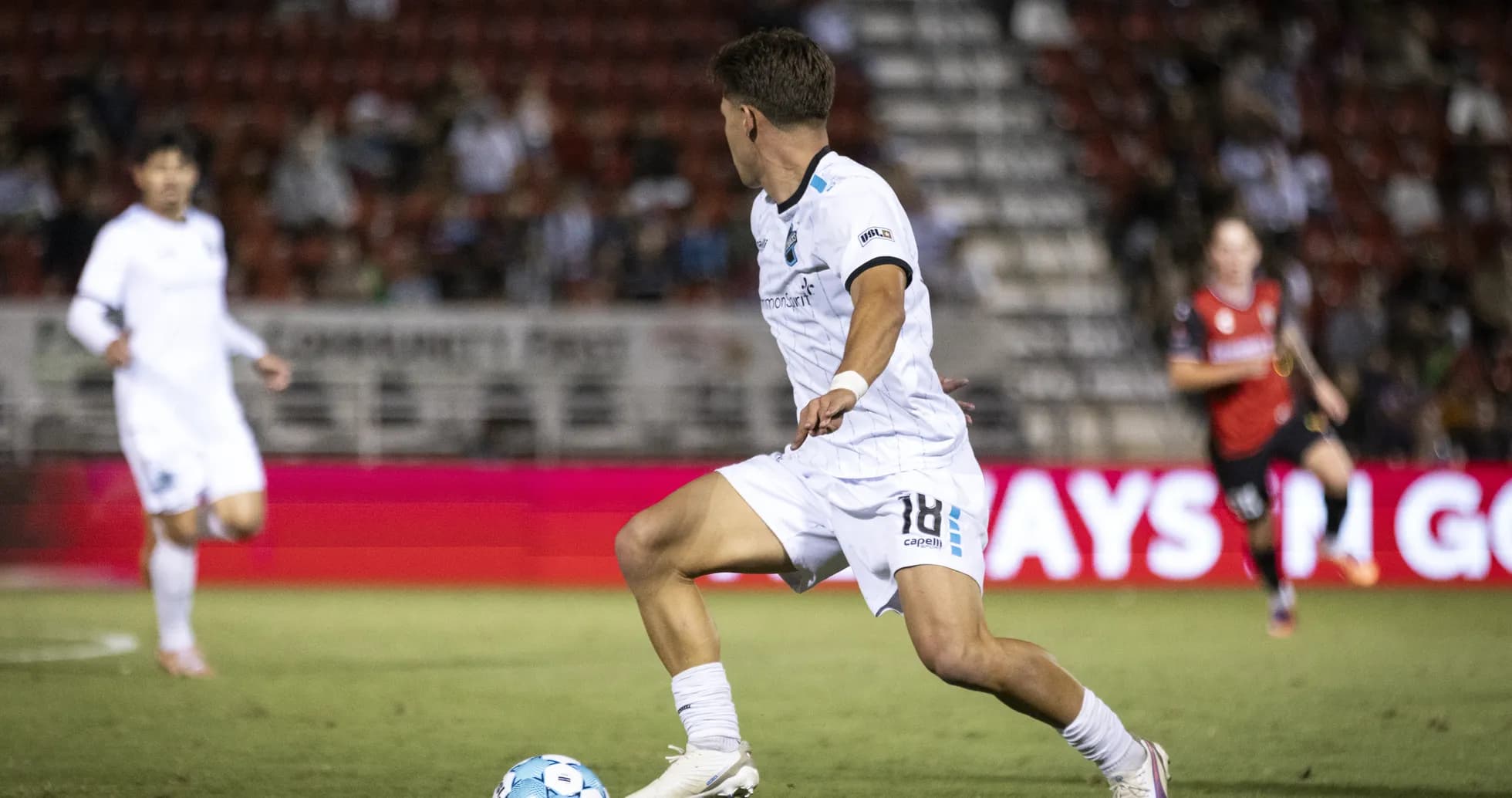 Player dribbling the ball during USL Championship match Player dribbling the ball during USL Championship match