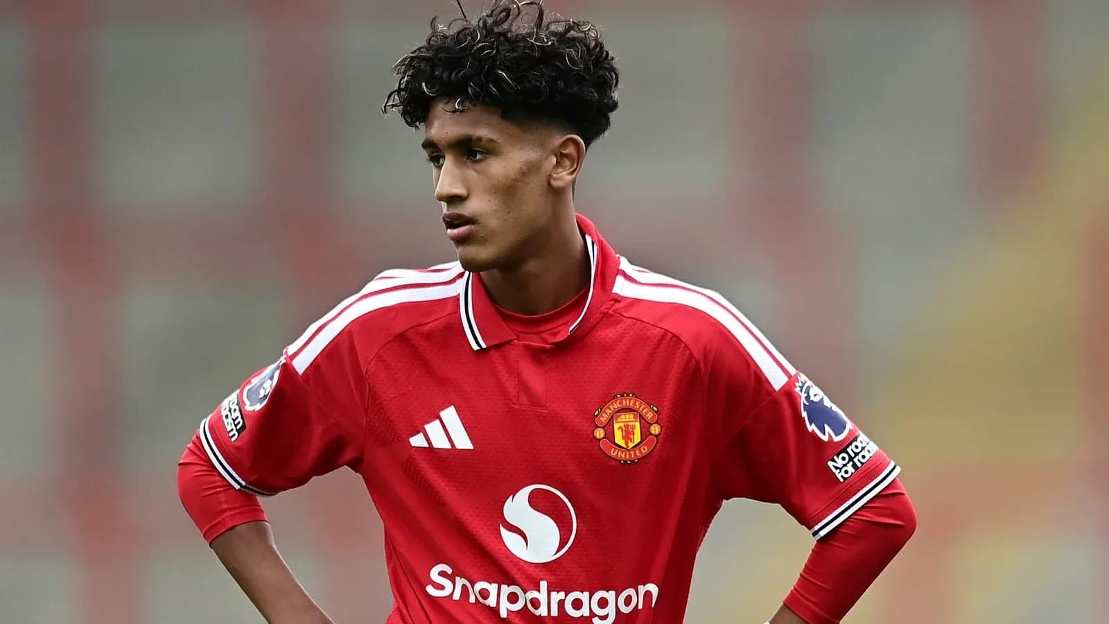 Player in red Manchester United kit on the field Player in red Manchester United kit on the field
