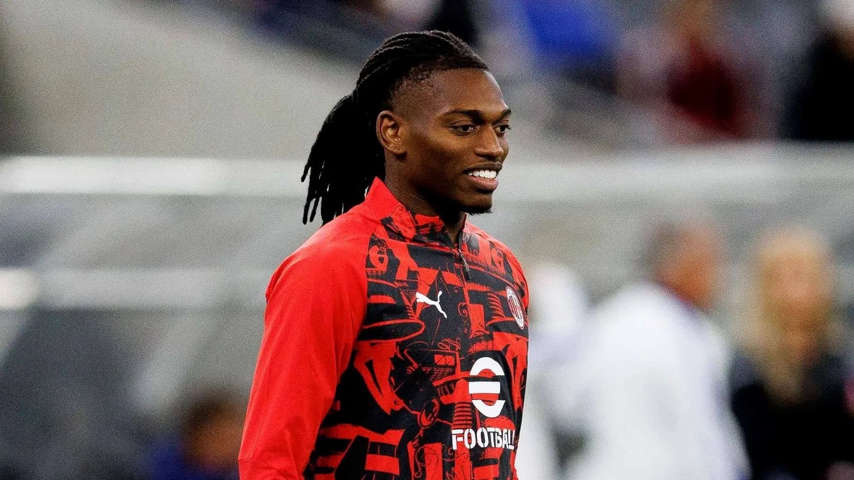 Player smiling in red training jacket before match Player smiling in red training jacket before match
