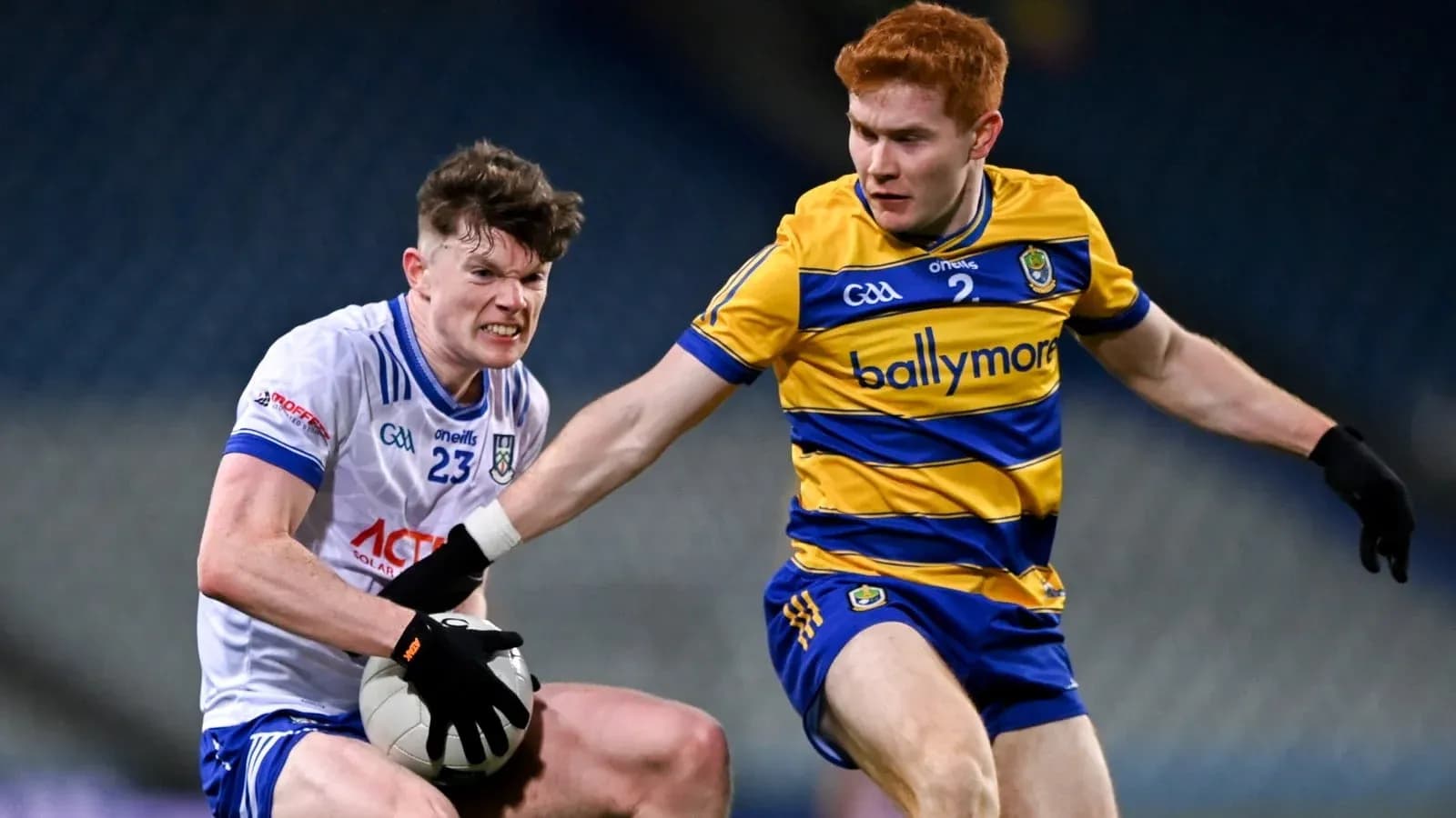 Two players contesting possession of a Gaelic football Two players contesting possession of a Gaelic football