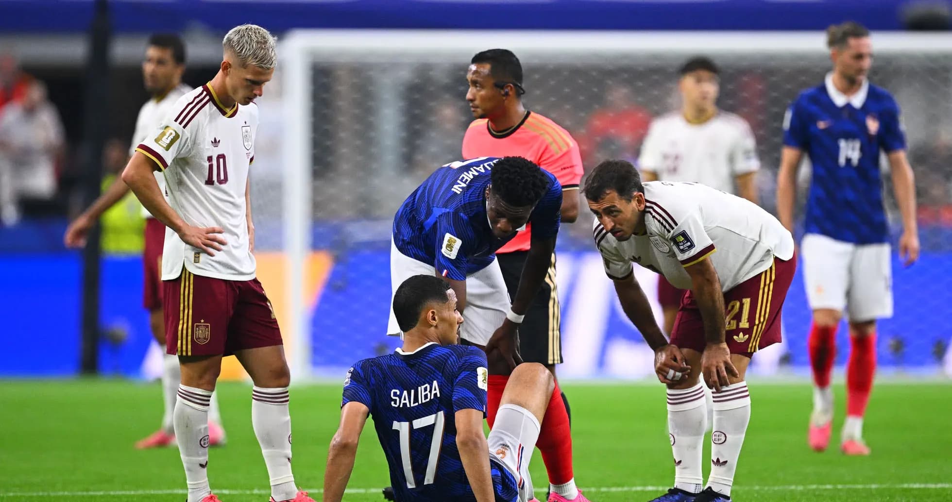 Players attending to injured teammate during match Players attending to injured teammate during match
