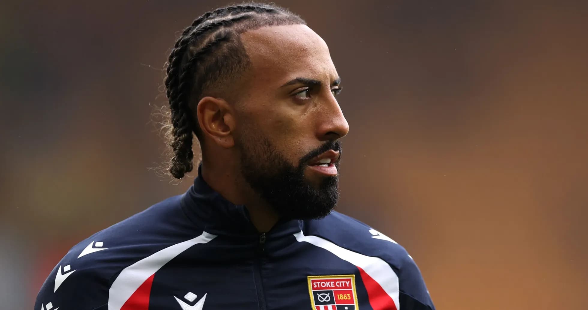 Player wearing Stoke City training jacket on field Player wearing Stoke City training jacket on field