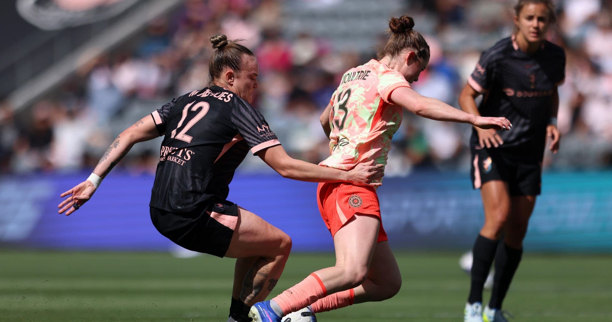Player tackling opponent during NWSL match Player tackling opponent during NWSL match