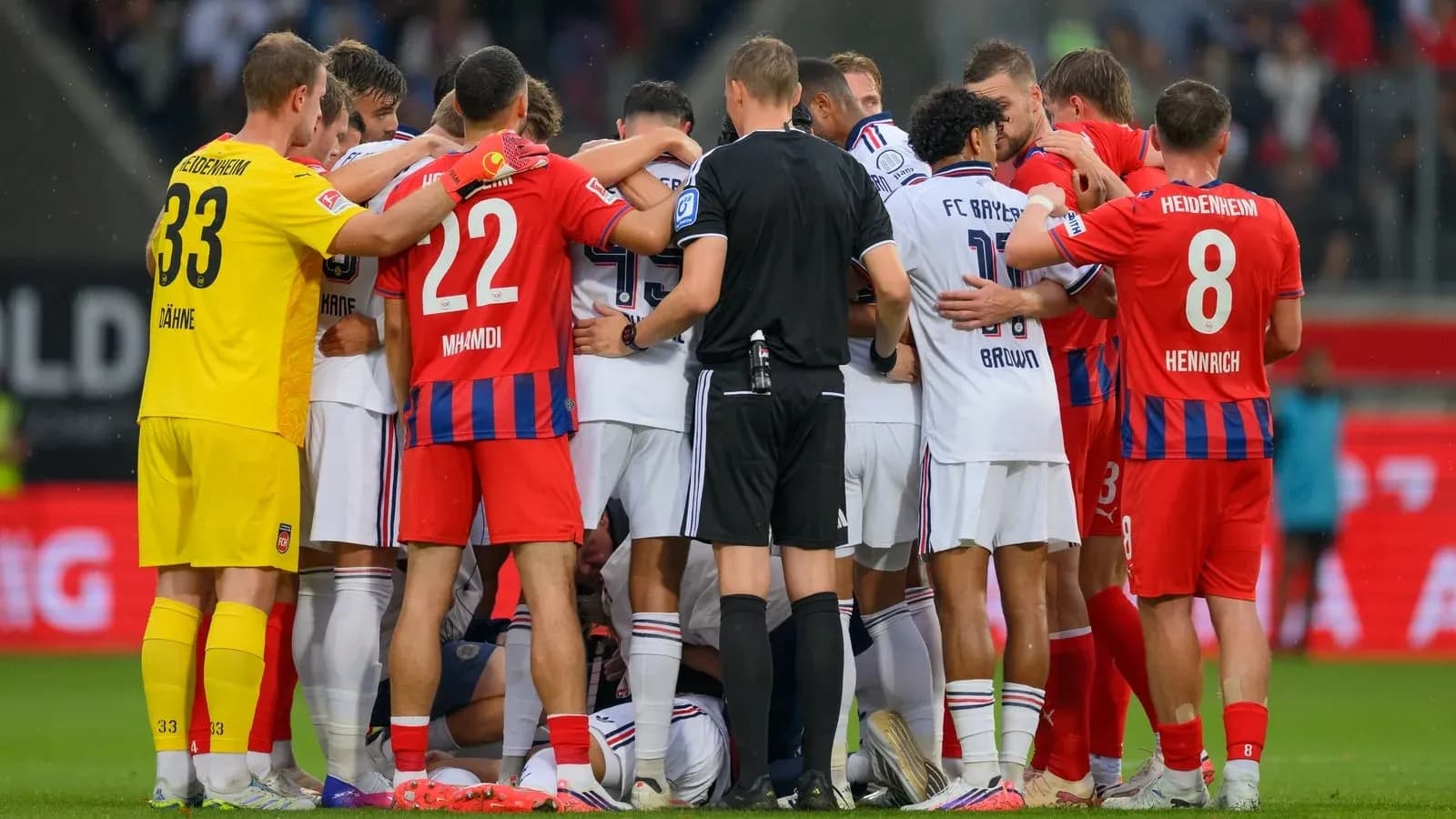 Players from both teams gathered during a stoppage Players from both teams gathered during a stoppage