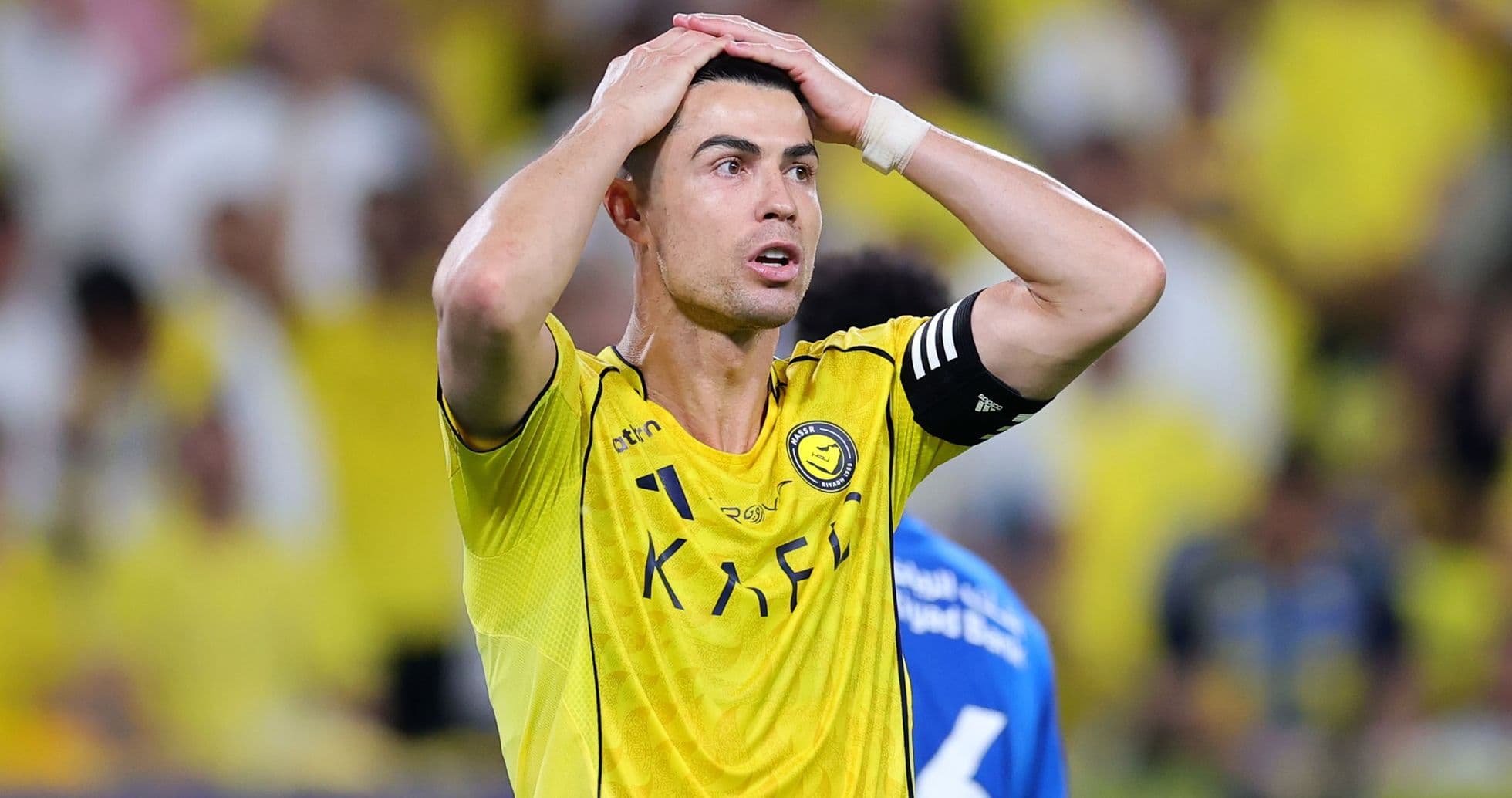 Player in yellow jersey with hands on head Player in yellow jersey with hands on head