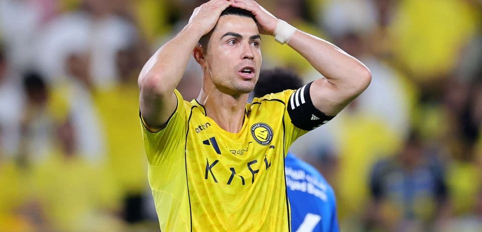 Player in yellow jersey with hands on head Player in yellow jersey with hands on head