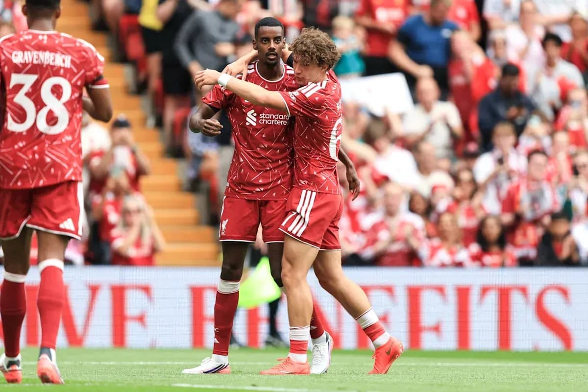 Liverpool players celebrating on the pitch together Liverpool players celebrating on the pitch together