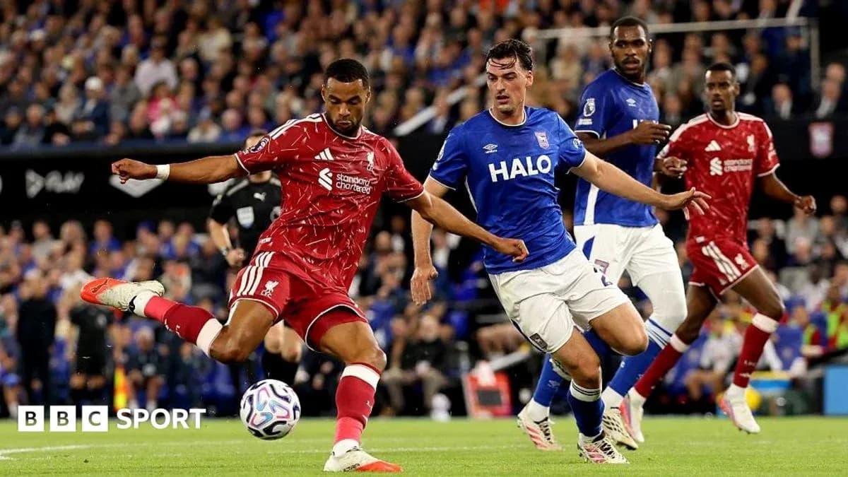 Liverpool player kicking the ball against Ipswich team Liverpool player kicking the ball against Ipswich team
