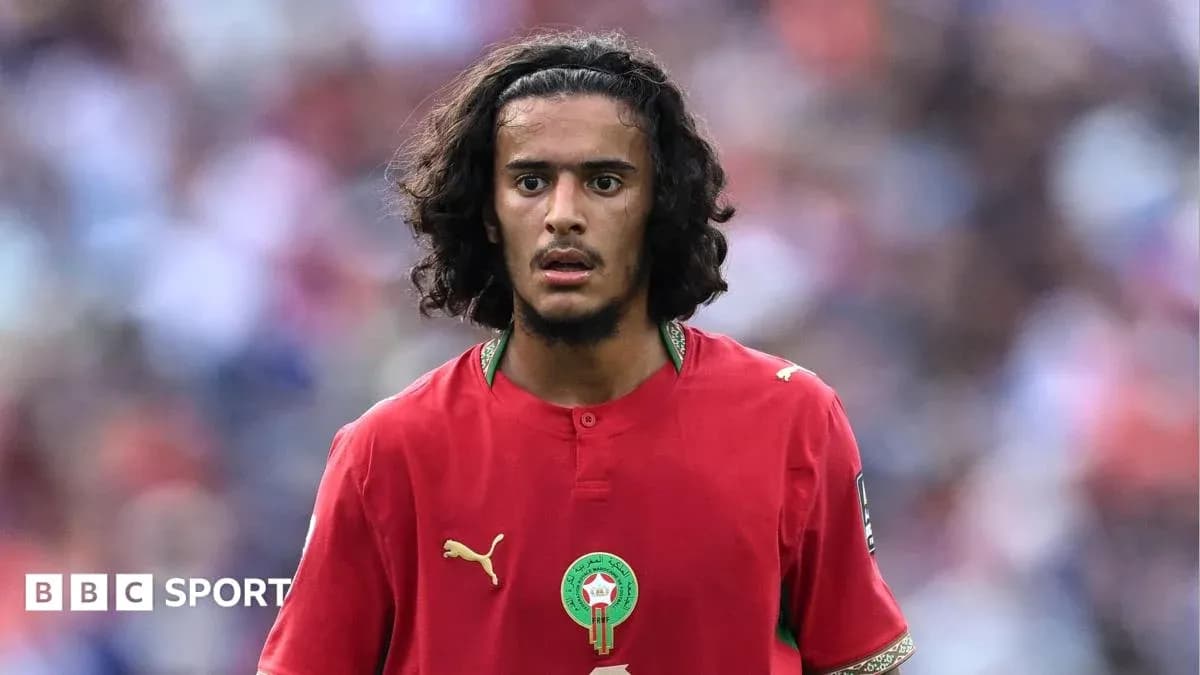 Moroccan player in red jersey on the field Moroccan player in red jersey on the field