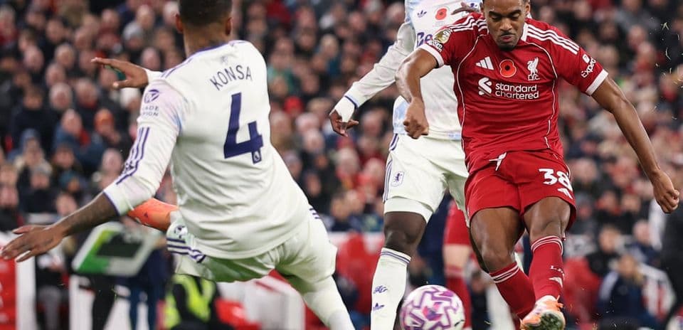 Aston Villa player tackling Liverpool forward Aston Villa player tackling Liverpool forward
