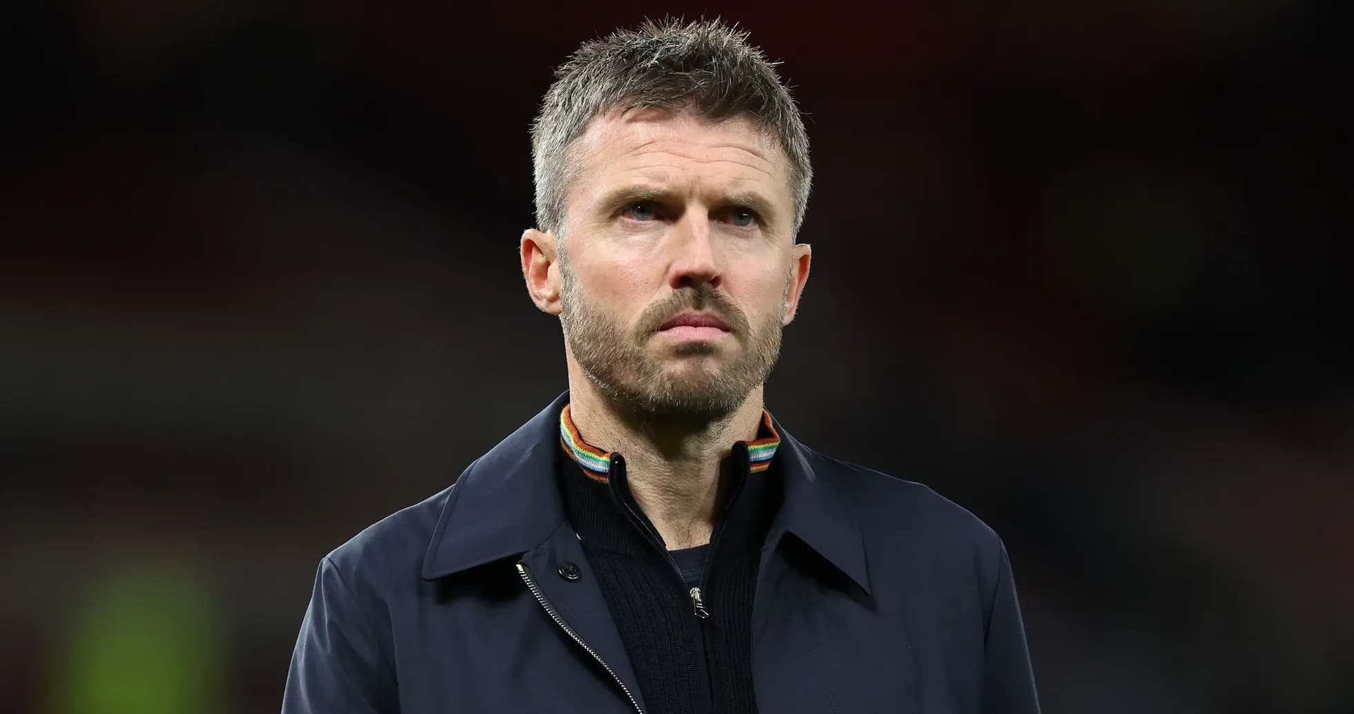 Man in a dark coat during a match Man in a dark coat during a match