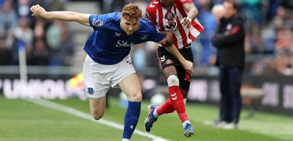 Everton player tackling Sunderland opponent in match Everton player tackling Sunderland opponent in match
