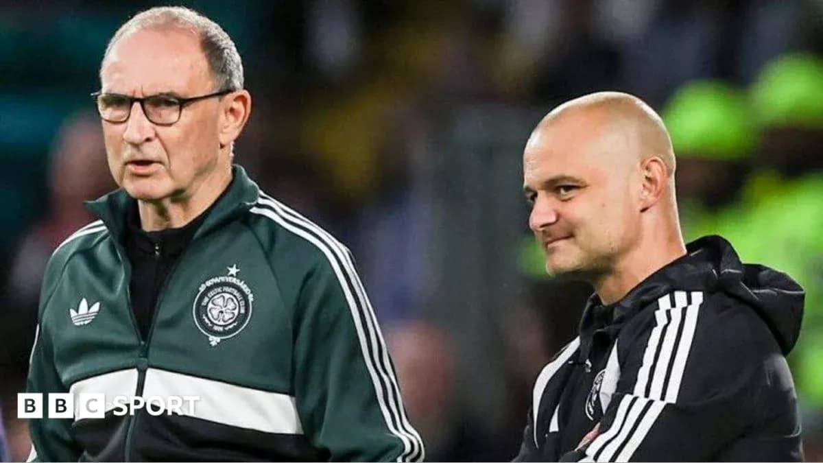 Two coaches discussing during a football match Two coaches discussing during a football match