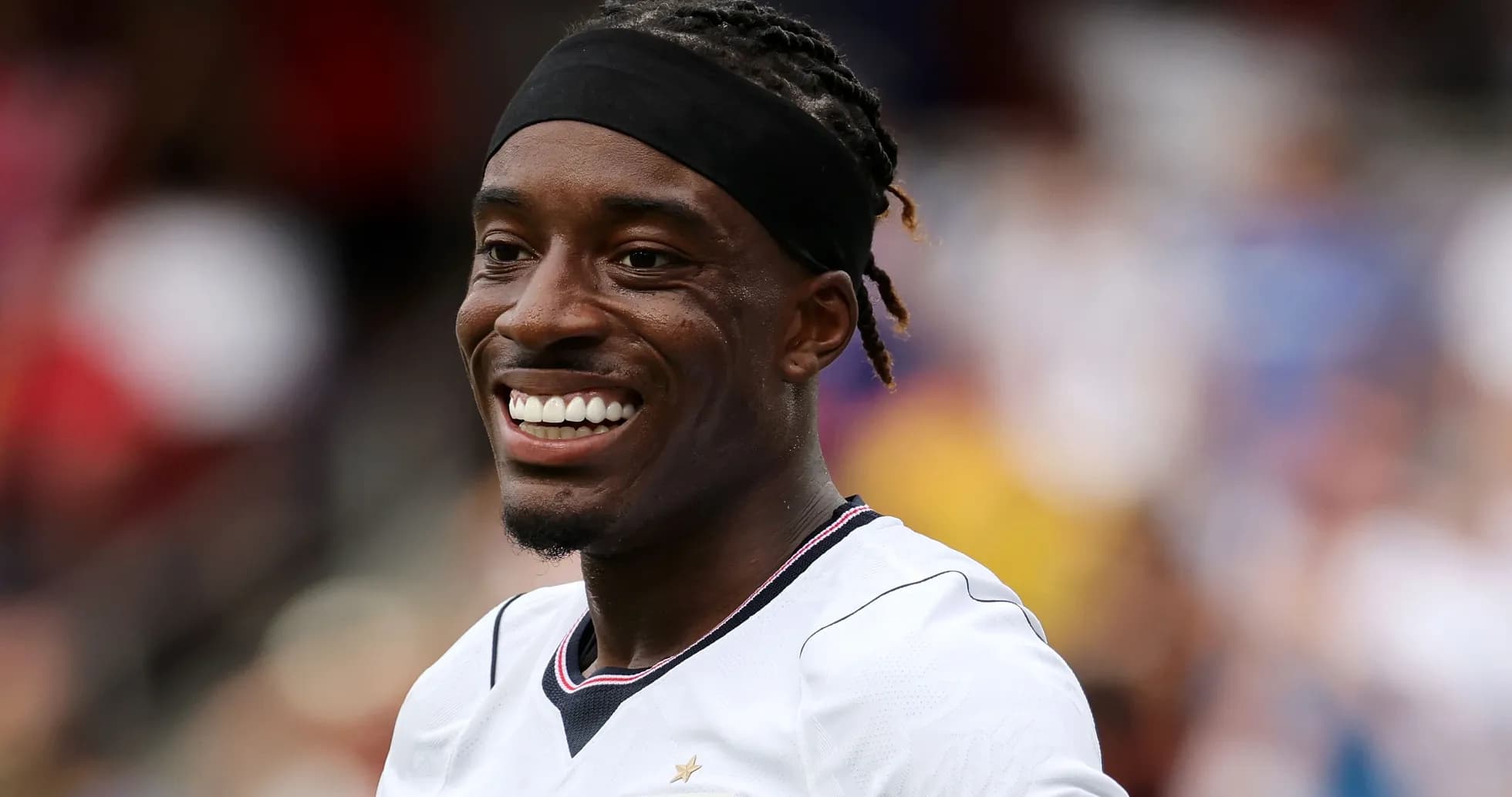 Player smiling during a match on the field Player smiling during a match on the field
