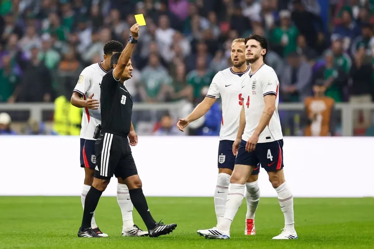 Referee shows yellow card to England player Referee shows yellow card to England player