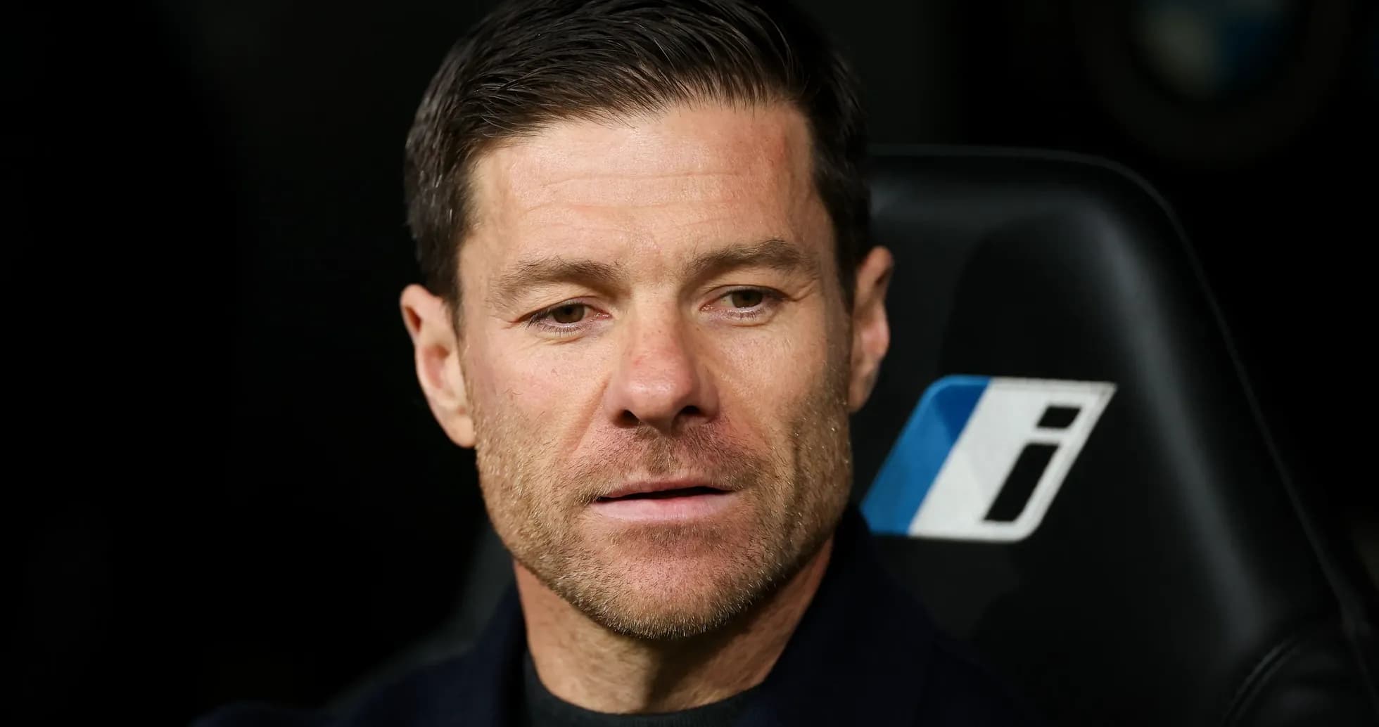 Coach sitting on bench during match Coach sitting on bench during match