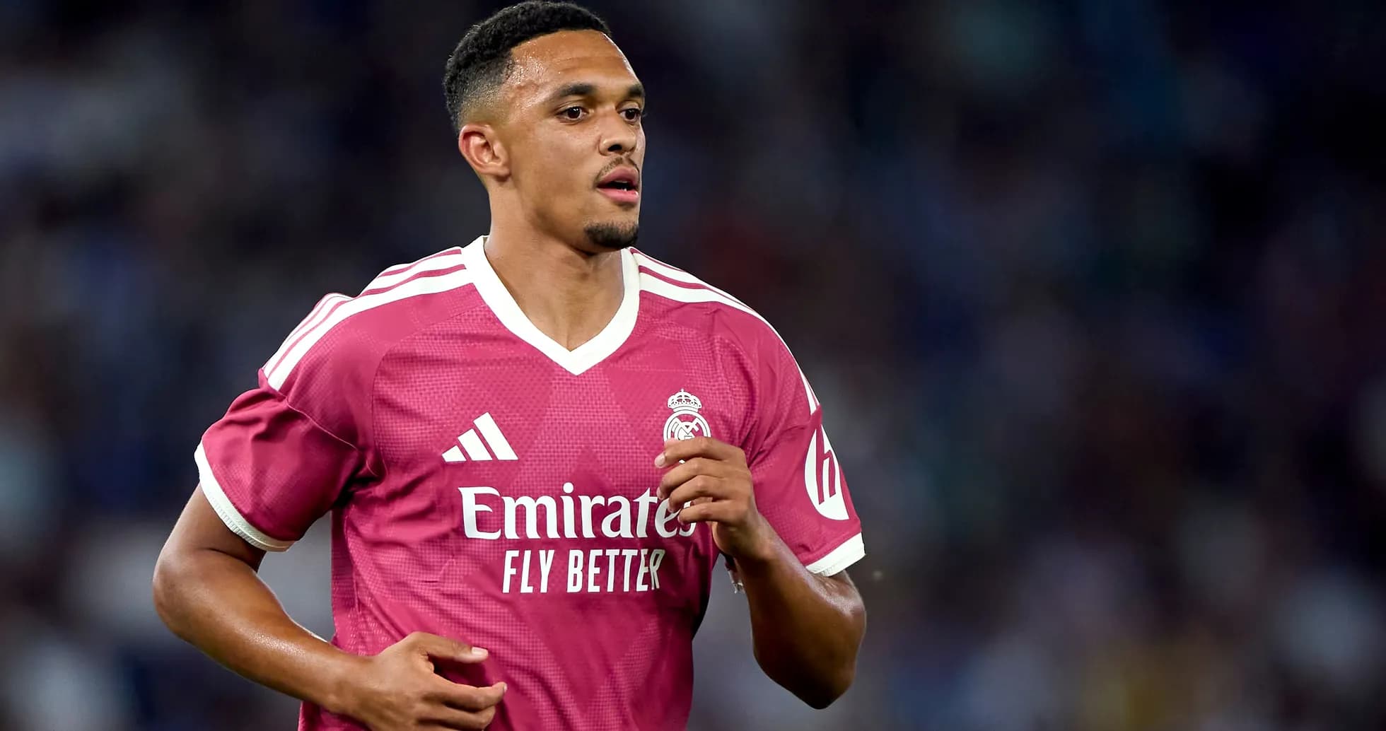 Player running on field in pink Real Madrid jersey Player running on field in pink Real Madrid jersey