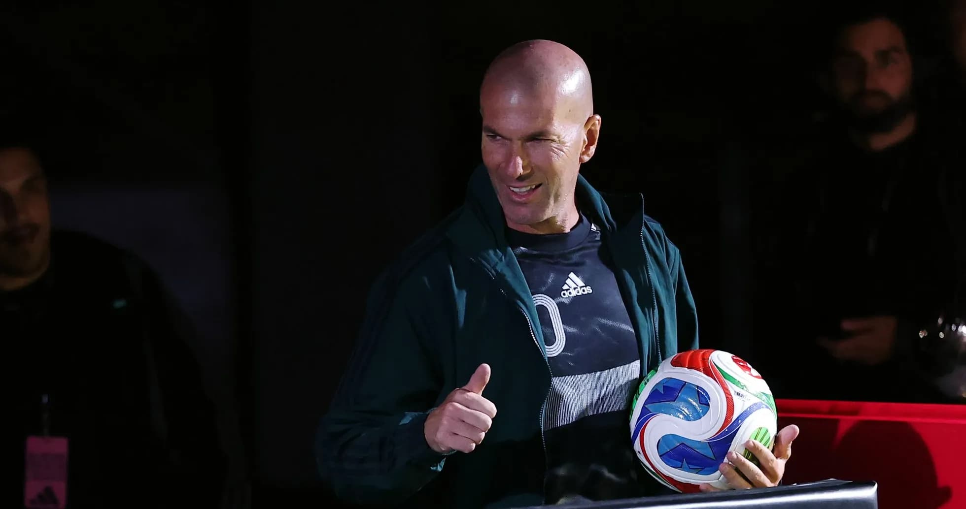 Zinedine Zidane holding a soccer ball and giving thumbs up Zinedine Zidane holding a soccer ball and giving thumbs up