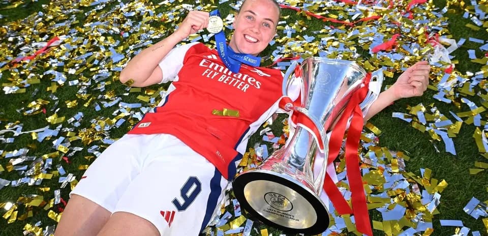 Player celebrating with trophy and medal on field Player celebrating with trophy and medal on field
