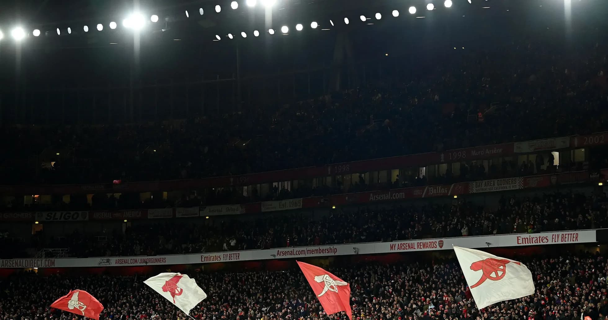 Fans waving flags in crowded stadium during match Fans waving flags in crowded stadium during match