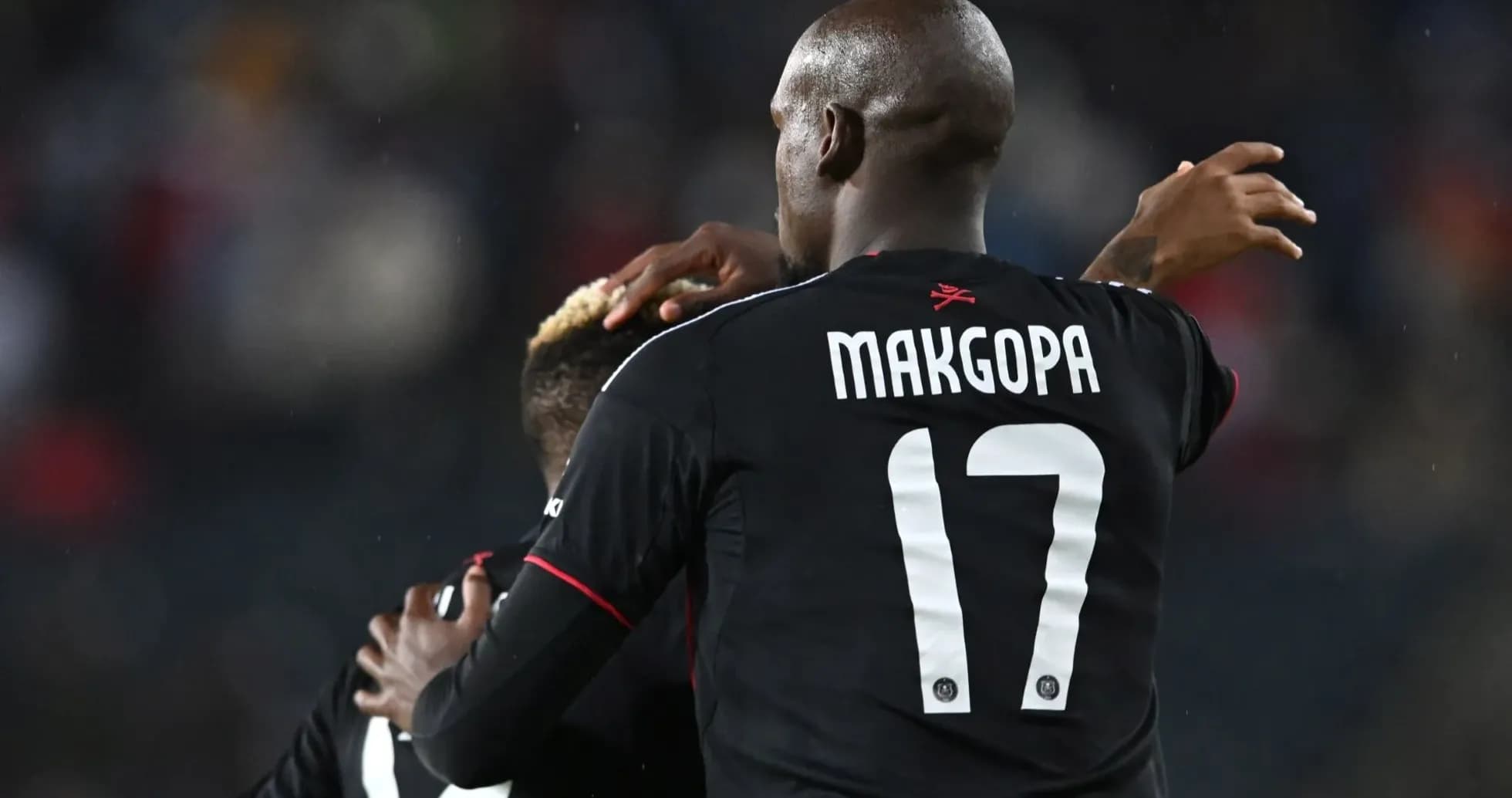 Player celebrating with teammate on the field Player celebrating with teammate on the field