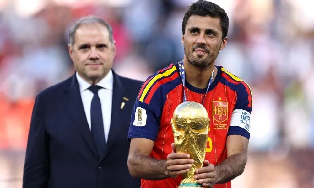 Player holding World Cup trophy with official nearby Player holding World Cup trophy with official nearby