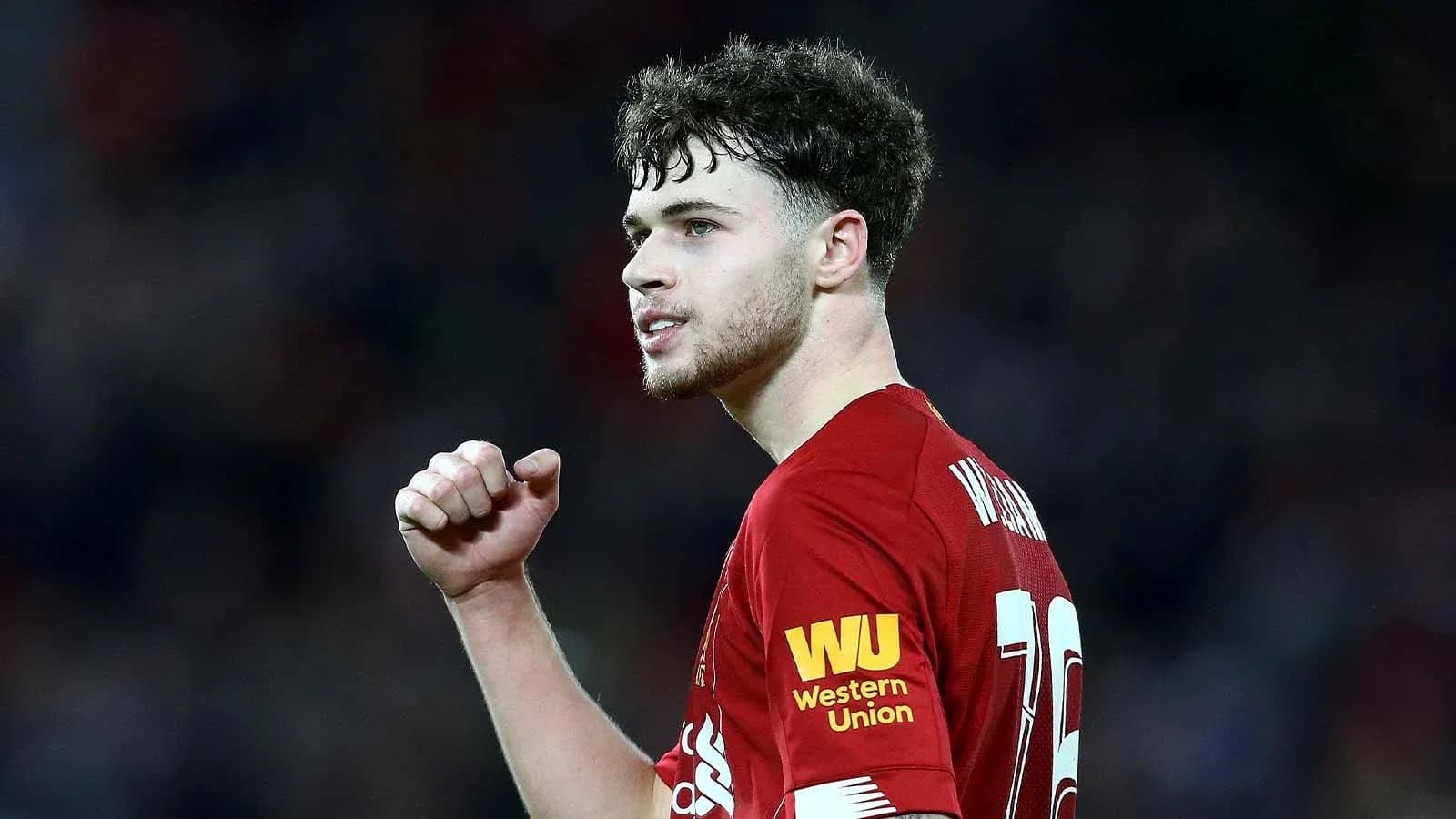 Player celebrating during a match for Liverpool Player celebrating during a match for Liverpool