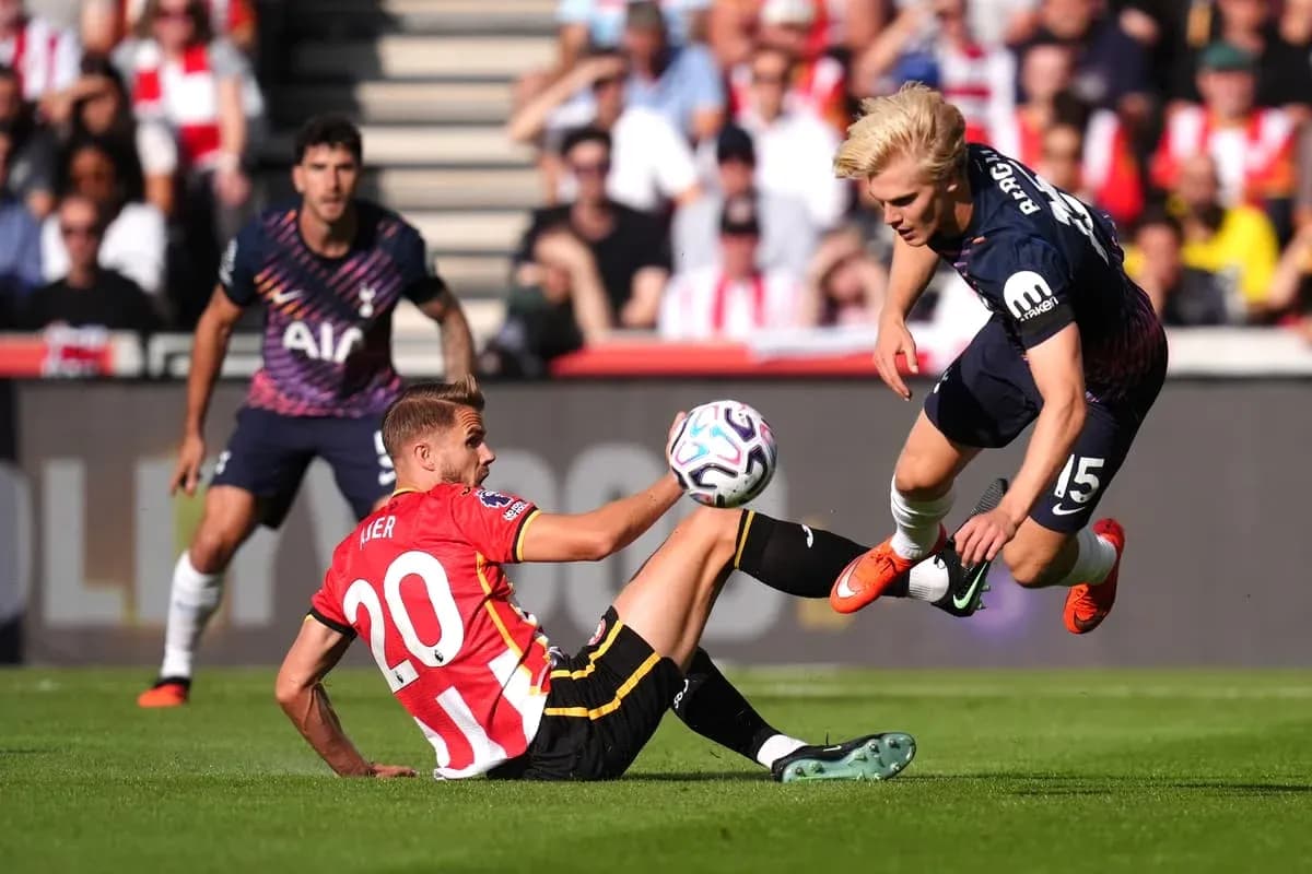 Player tackling another player during football match Player tackling another player during football match