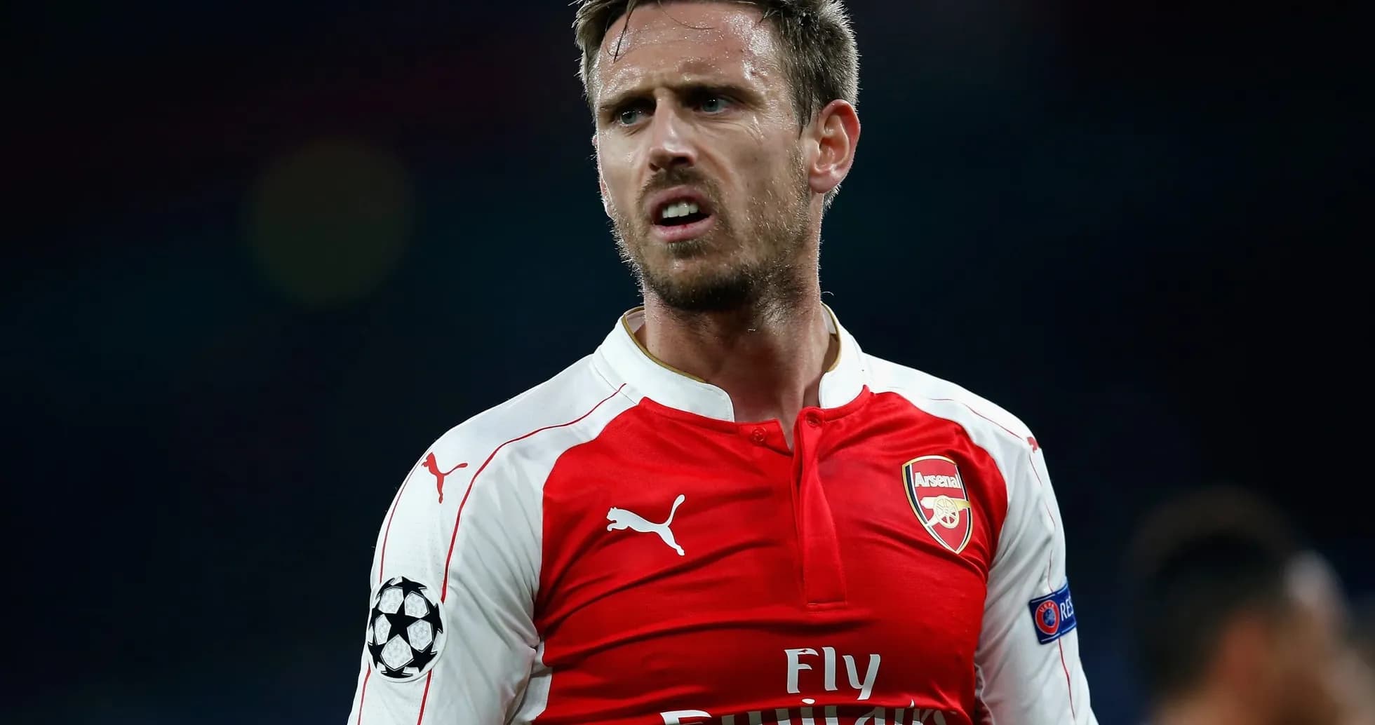 Arsenal player in red kit during match Arsenal player in red kit during match