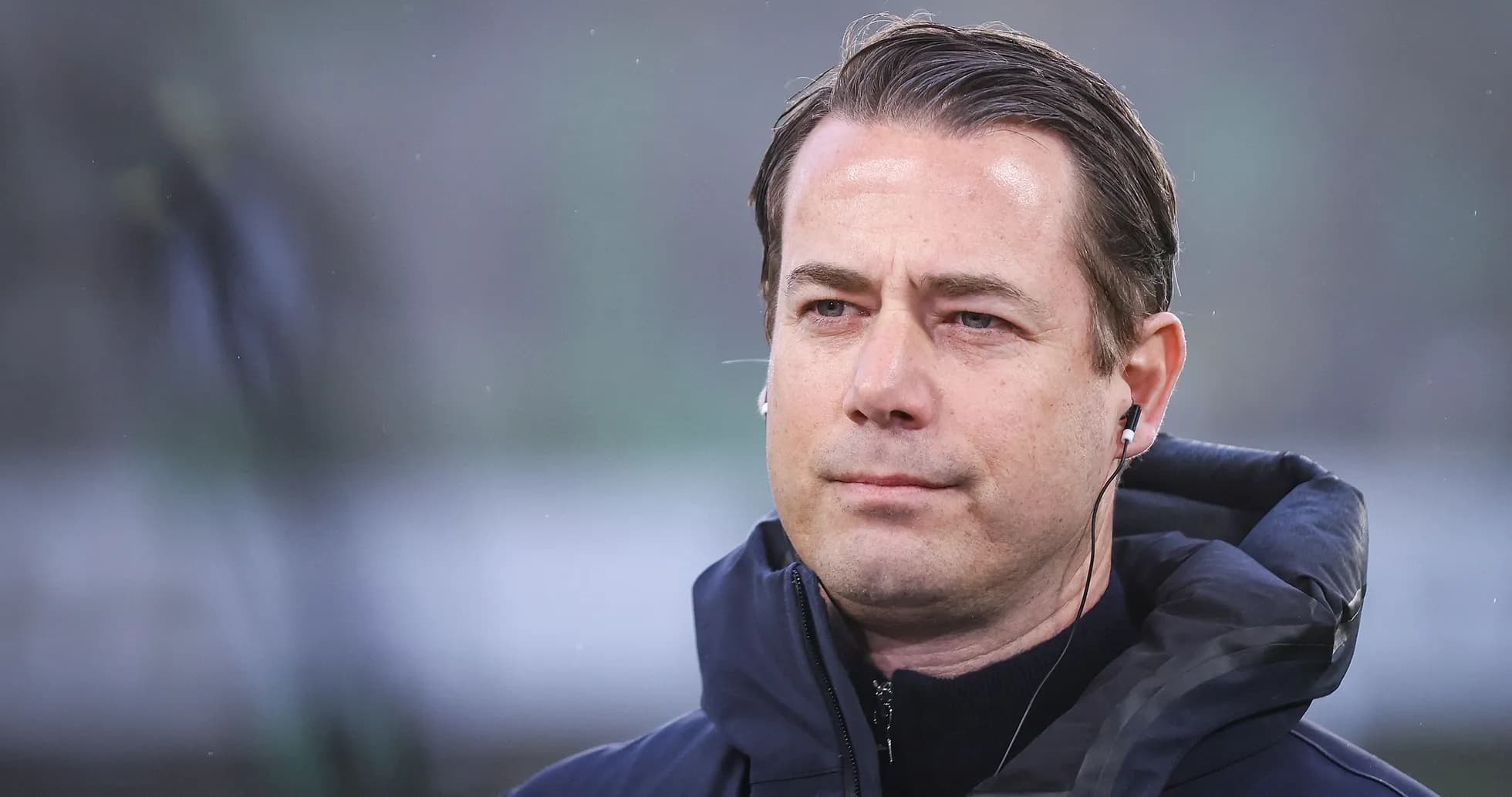 Man wearing headphones during a sporting event Man wearing headphones during a sporting event