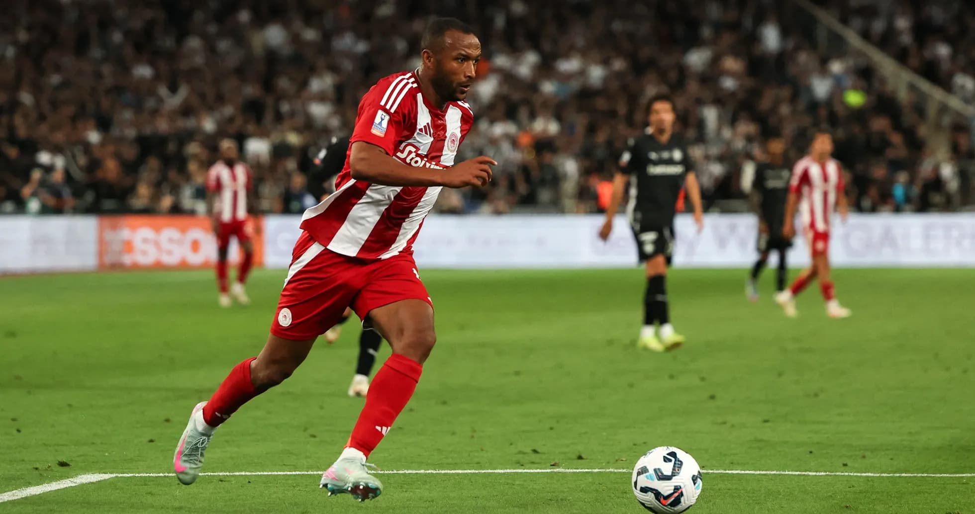 Player in red and white kit sprinting with ball Player in red and white kit sprinting with ball