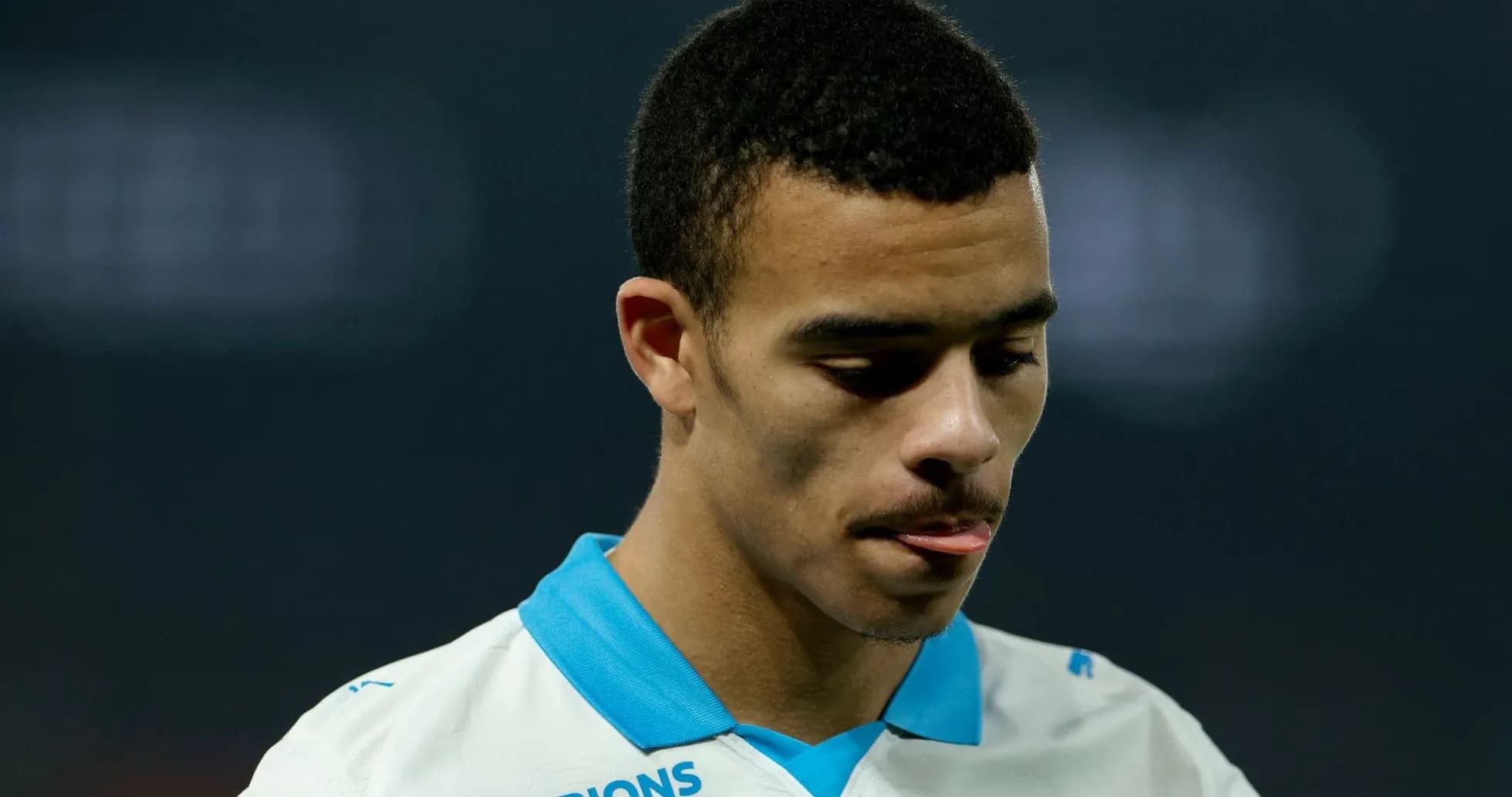 Player looking down, wearing team jersey Player looking down, wearing team jersey
