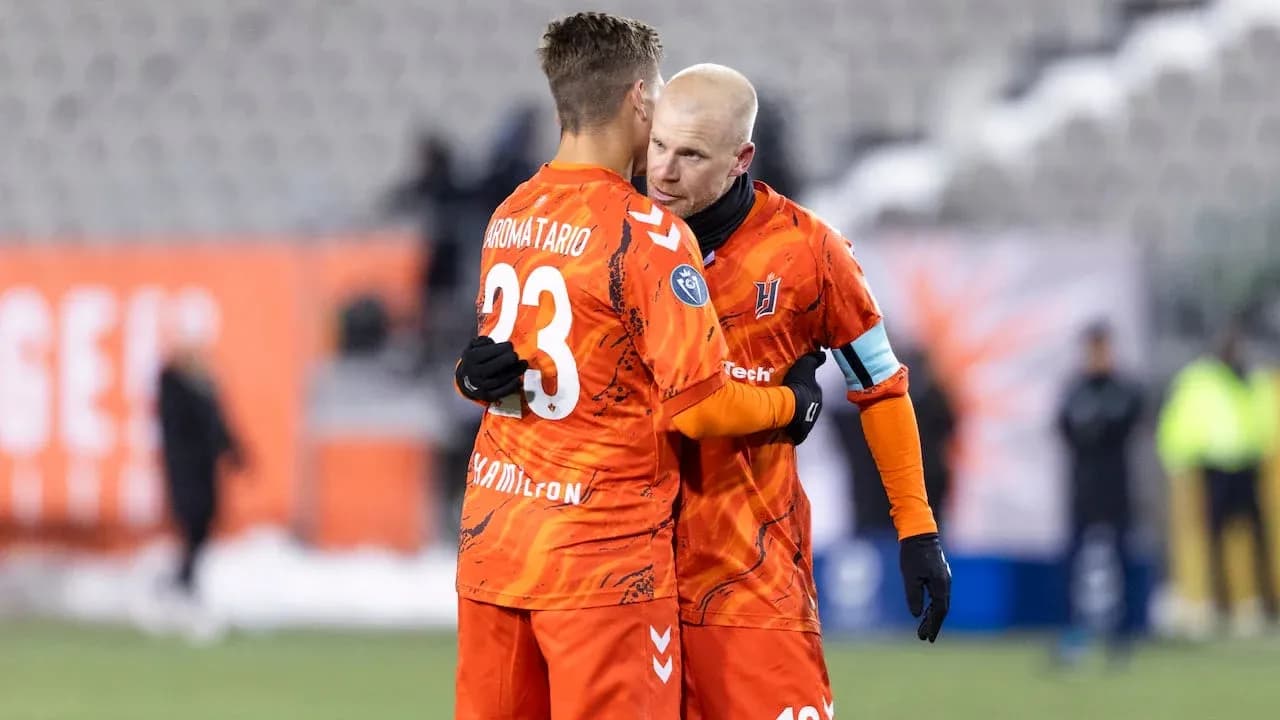 Two players embracing on the pitch Two players embracing on the pitch