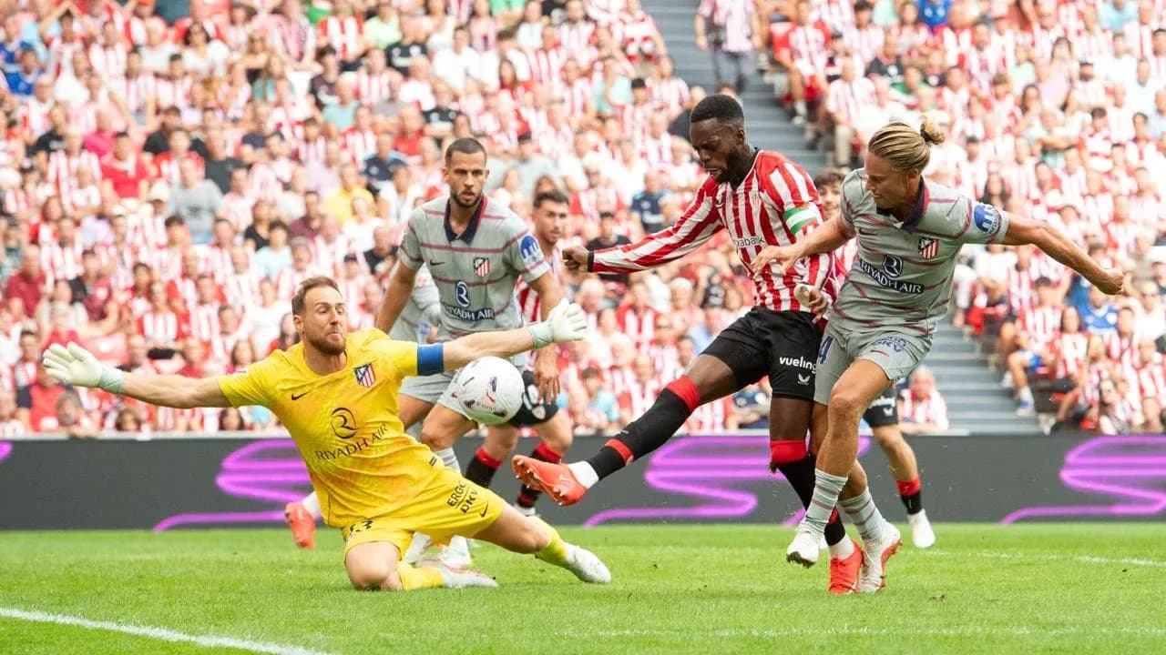 Athletic Club player attempts to score against Atletico Madrid Athletic Club player attempts to score against Atletico Madrid