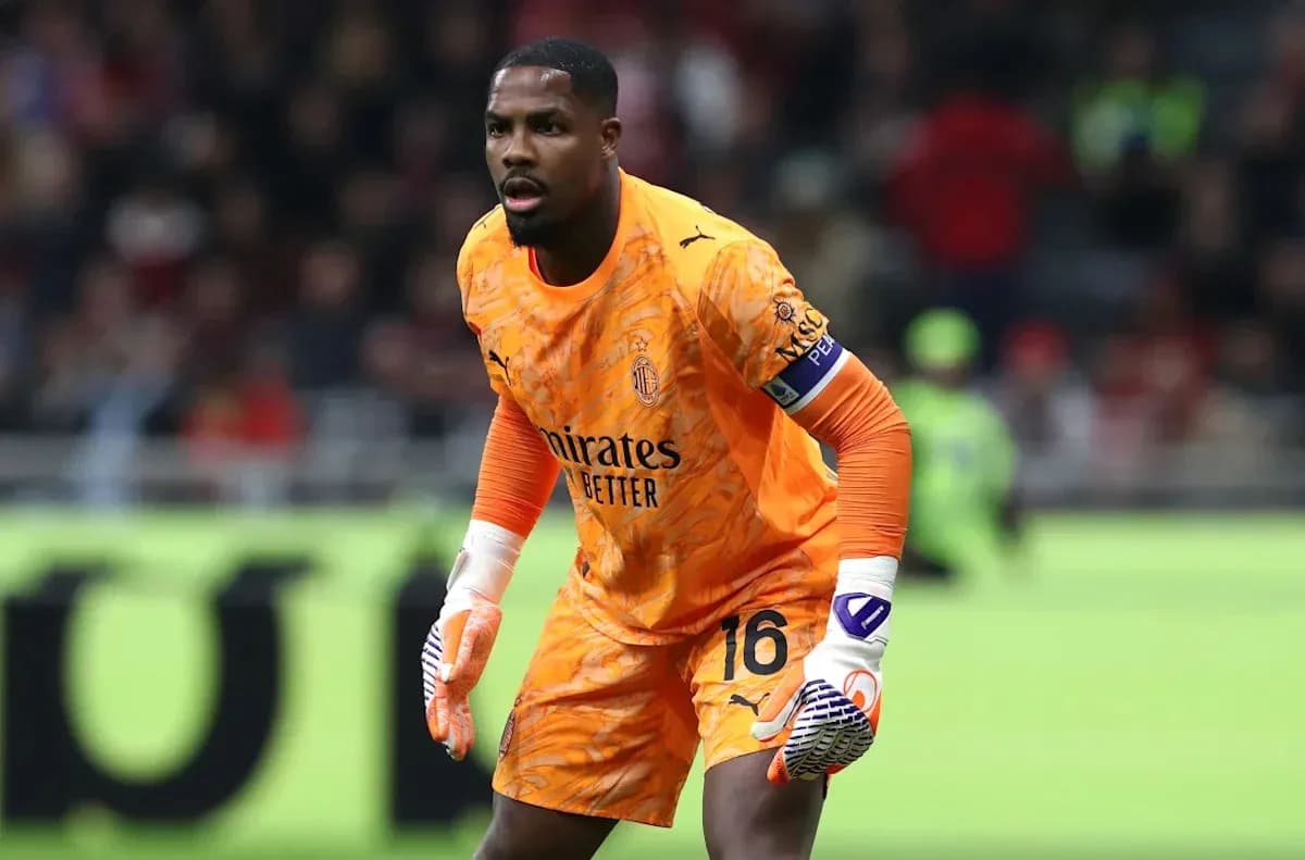 Goalkeeper in orange kit preparing for play Goalkeeper in orange kit preparing for play