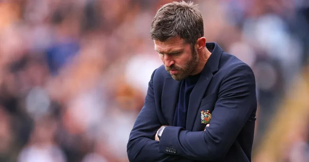 Coach with arms crossed looking down during match Coach with arms crossed looking down during match